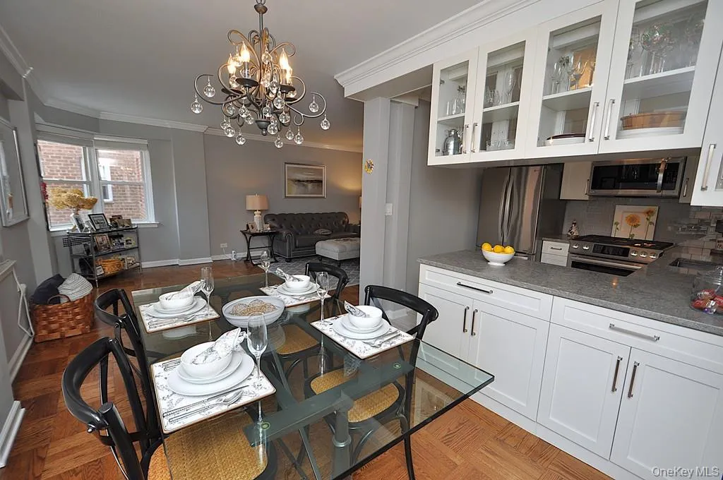 The dining area has a bay window and opens to both the living room and renovated kitchen. The dining room is approx 9'-0" x 8'-10" The dining area has a bay window and opens to both the living room and renovated kitchen. The dining room is approx 9'-0" x 8'-10"