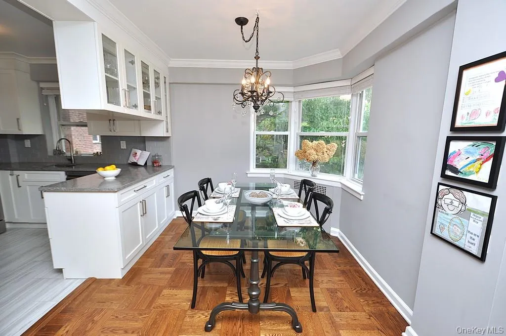 The dining area has a bay window and opens to both the living room and renovated kitchen. The dining room is approx 9'-0" x 8'-10" The dining area has a bay window and opens to both the living room and renovated kitchen. The dining room is approx 9'-0" x 8'-10"