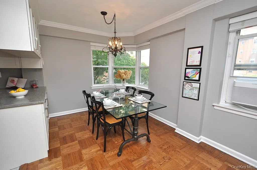 The dining area has a bay window and opens to both the living room and renovated kitchen. The dining room is approx 9'-0" x 8'-10" The dining area has a bay window and opens to both the living room and renovated kitchen. The dining room is approx 9'-0" x 8'-10"