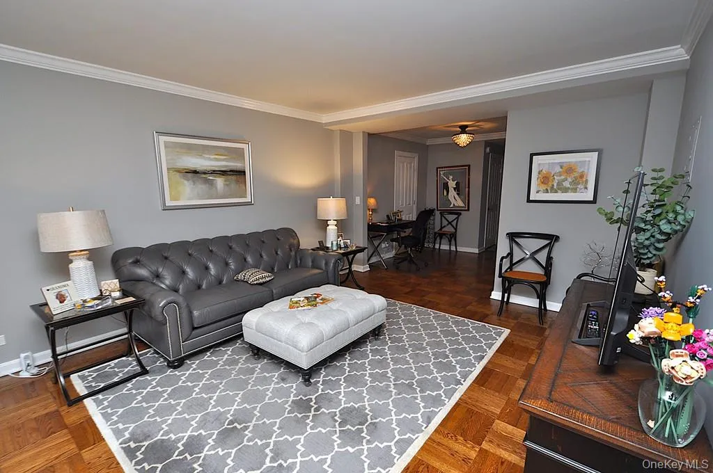 The large living room has refinished parquet floors, a bay window and opens to both the dining room and foyer. The living room is approx 21'-5' x 12'-6" . The large living room has refinished parquet floors, a bay window and opens to both the dining room and foyer. The living room is approx 21'-5' x 12'-6" .