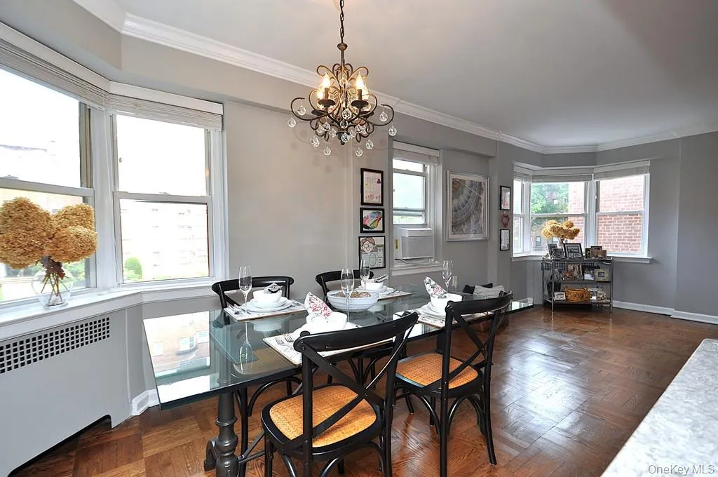 The dining area has a bay window and opens to both the living room and renovated kitchen. The dining room is approx 9'-0" x 8'-10" The dining area has a bay window and opens to both the living room and renovated kitchen. The dining room is approx 9'-0" x 8'-10"