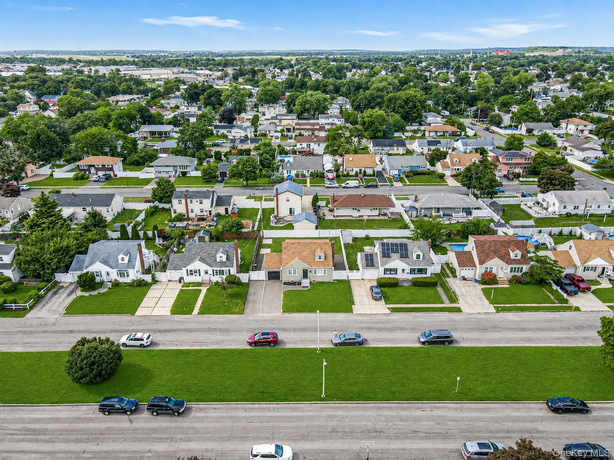 Wide street with extra walkable green space in the center. Lawn digitally enhanced. Wide street with extra walkable green space in the center. Lawn digitally enhanced.