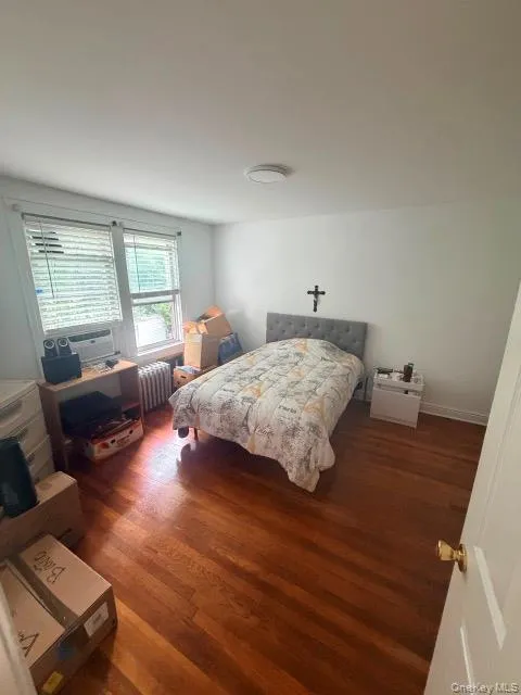 Hardwood flooring, two windows with blinds, flush mount ceiling light, and white walls Hardwood flooring, two windows with blinds, flush mount ceiling light, and white walls