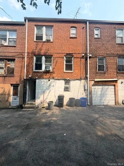 Brick exterior building with multiple windows and a garage door Brick exterior building with multiple windows and a garage door