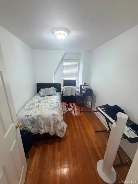 Wood-finish flooring with white painted walls and a flush-mount ceiling light Wood-finish flooring with white painted walls and a flush-mount ceiling light