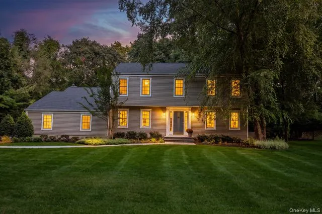 Traditional-style residence with horizontal siding, gray roof, and multiple windows Traditional-style residence with horizontal siding, gray roof, and multiple windows