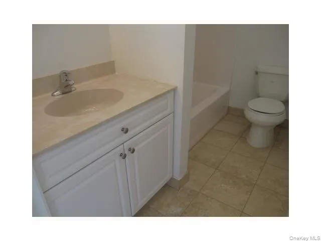 The hallway bath has a shower/tub combination and a ceramic tile floor The hallway bath has a shower/tub combination and a ceramic tile floor