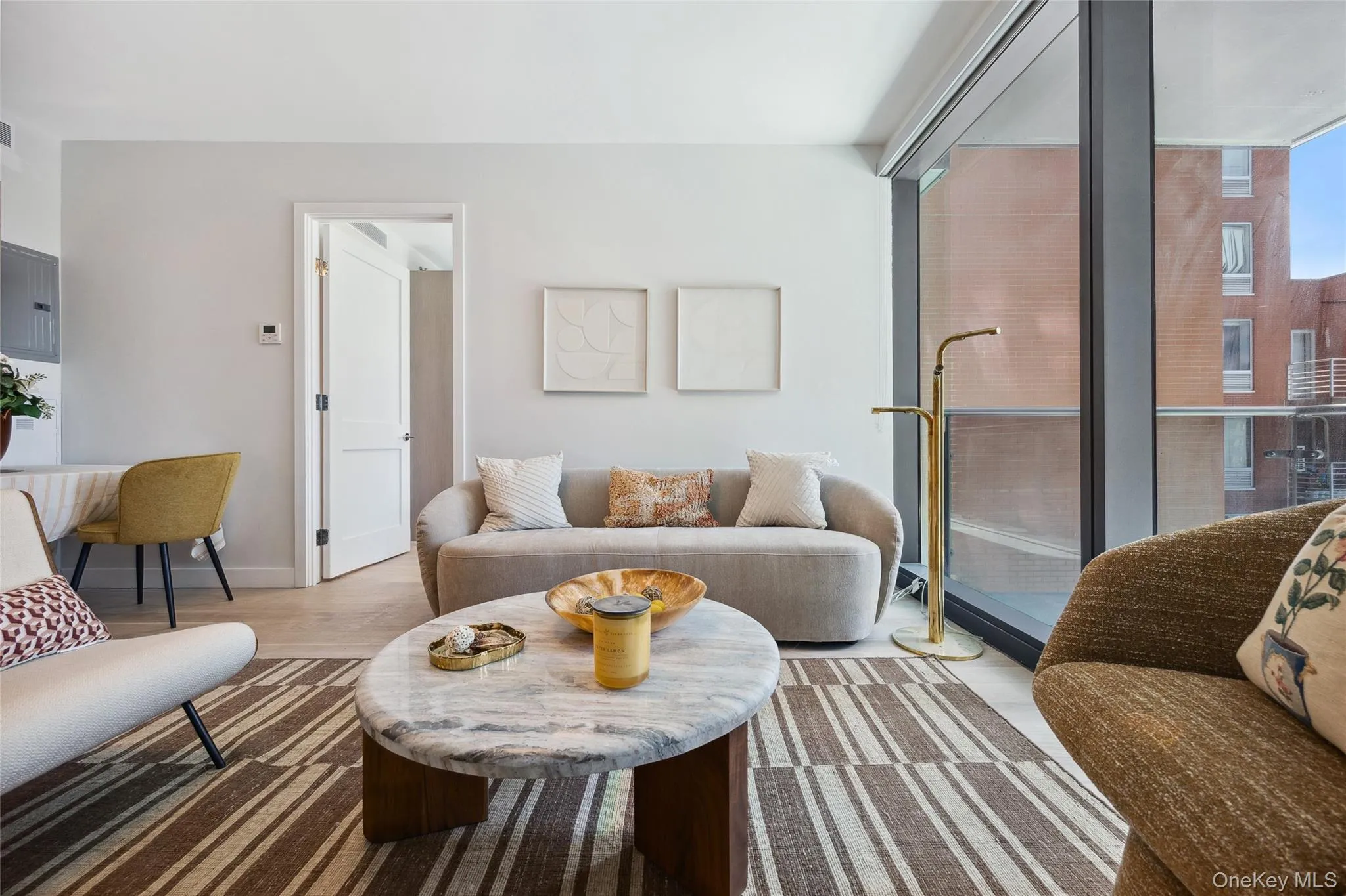 Living area with wood finished floors, baseboards, and expansive windows Living area with wood finished floors, baseboards, and expansive windows