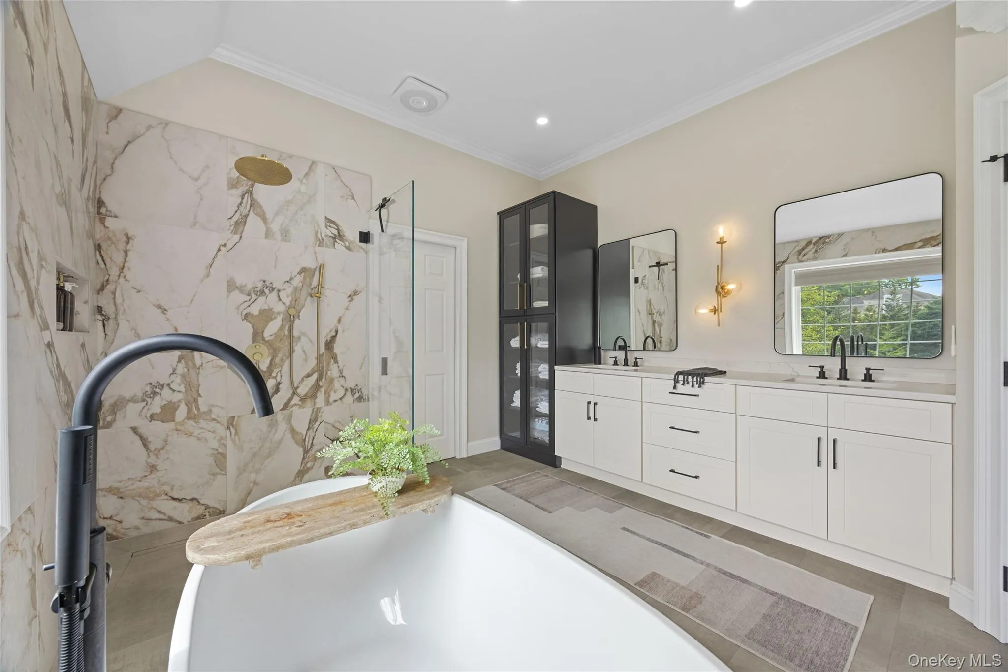 Bathroom with a soaking tub, a marble finish shower, crown molding, double vanity, and recessed lighting Bathroom with a soaking tub, a marble finish shower, crown molding, double vanity, and recessed lighting