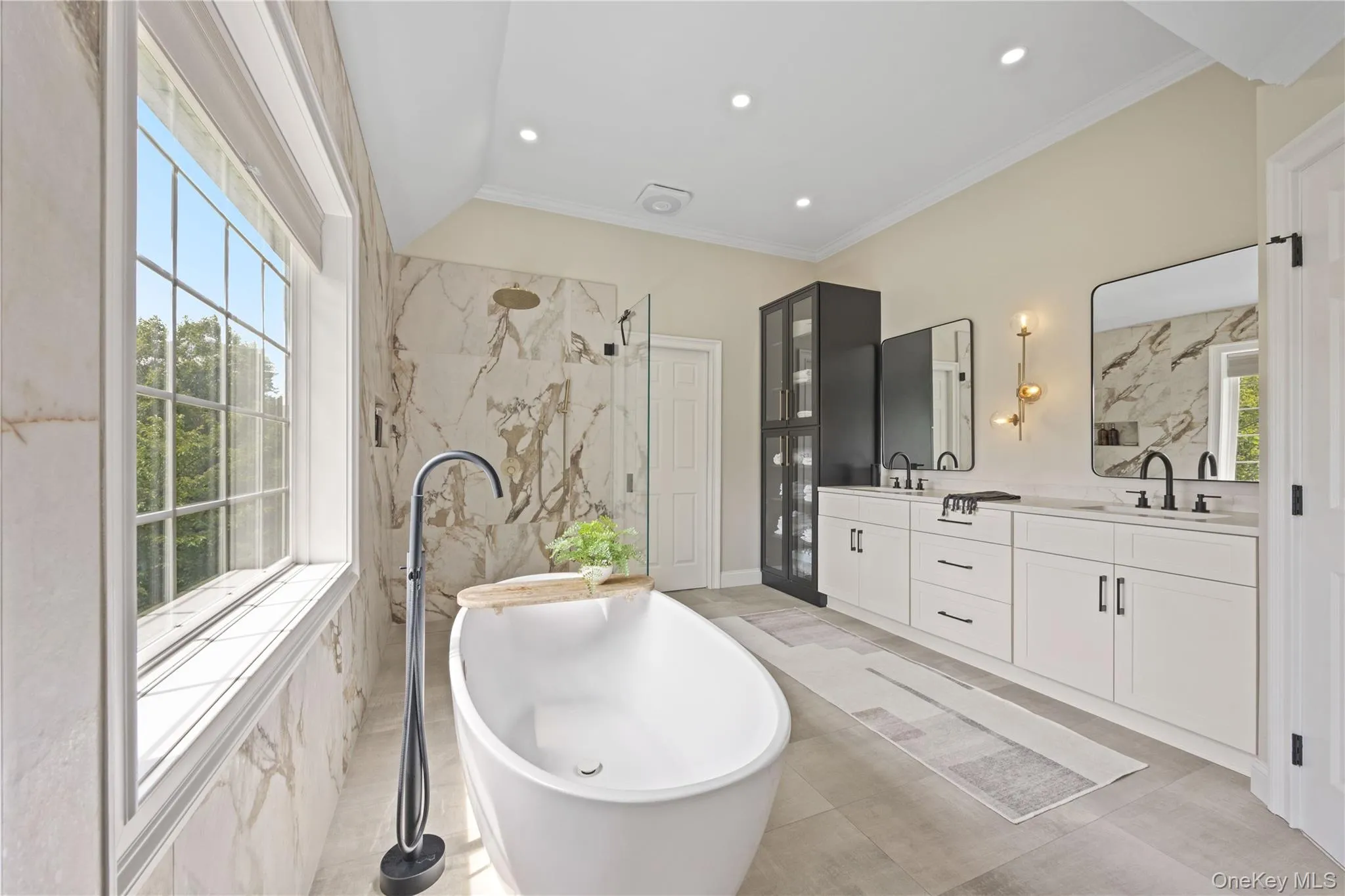 Bathroom with a soaking tub, double vanity, a marble finish shower, crown molding, and vaulted ceiling Bathroom with a soaking tub, double vanity, a marble finish shower, crown molding, and vaulted ceiling