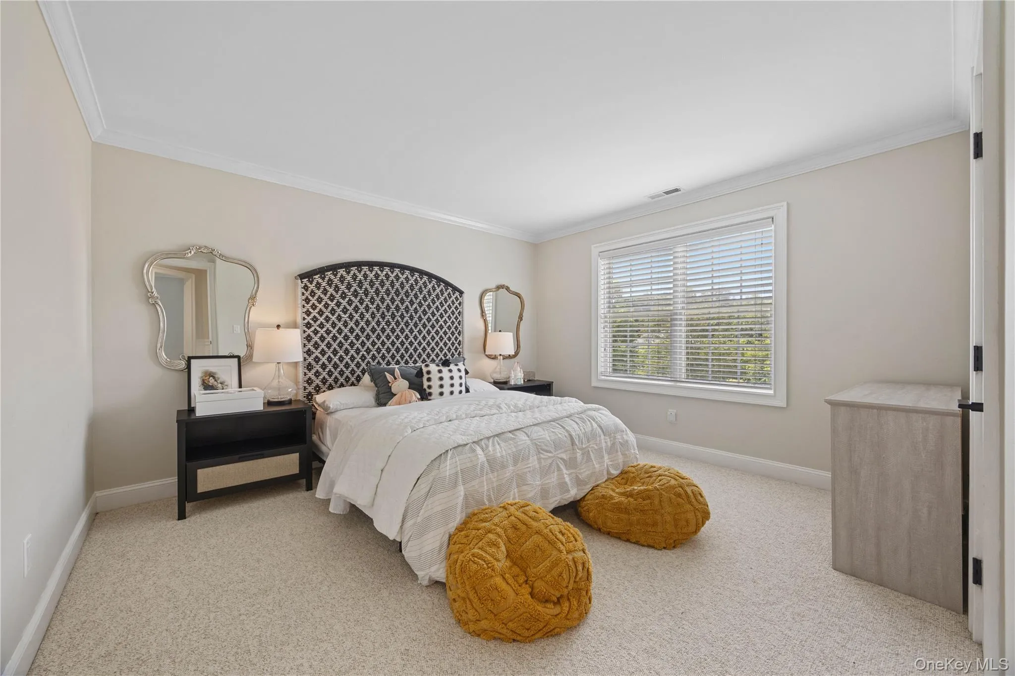 Carpeted bedroom featuring crown molding Carpeted bedroom featuring crown molding
