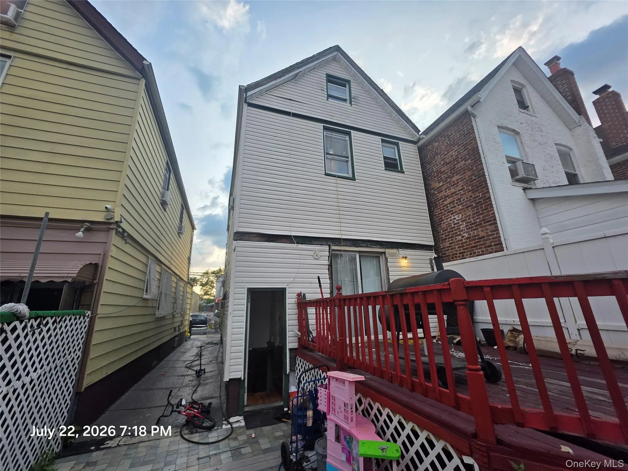 Rear exterior with white siding and a three-story configuration Rear exterior with white siding and a three-story configuration