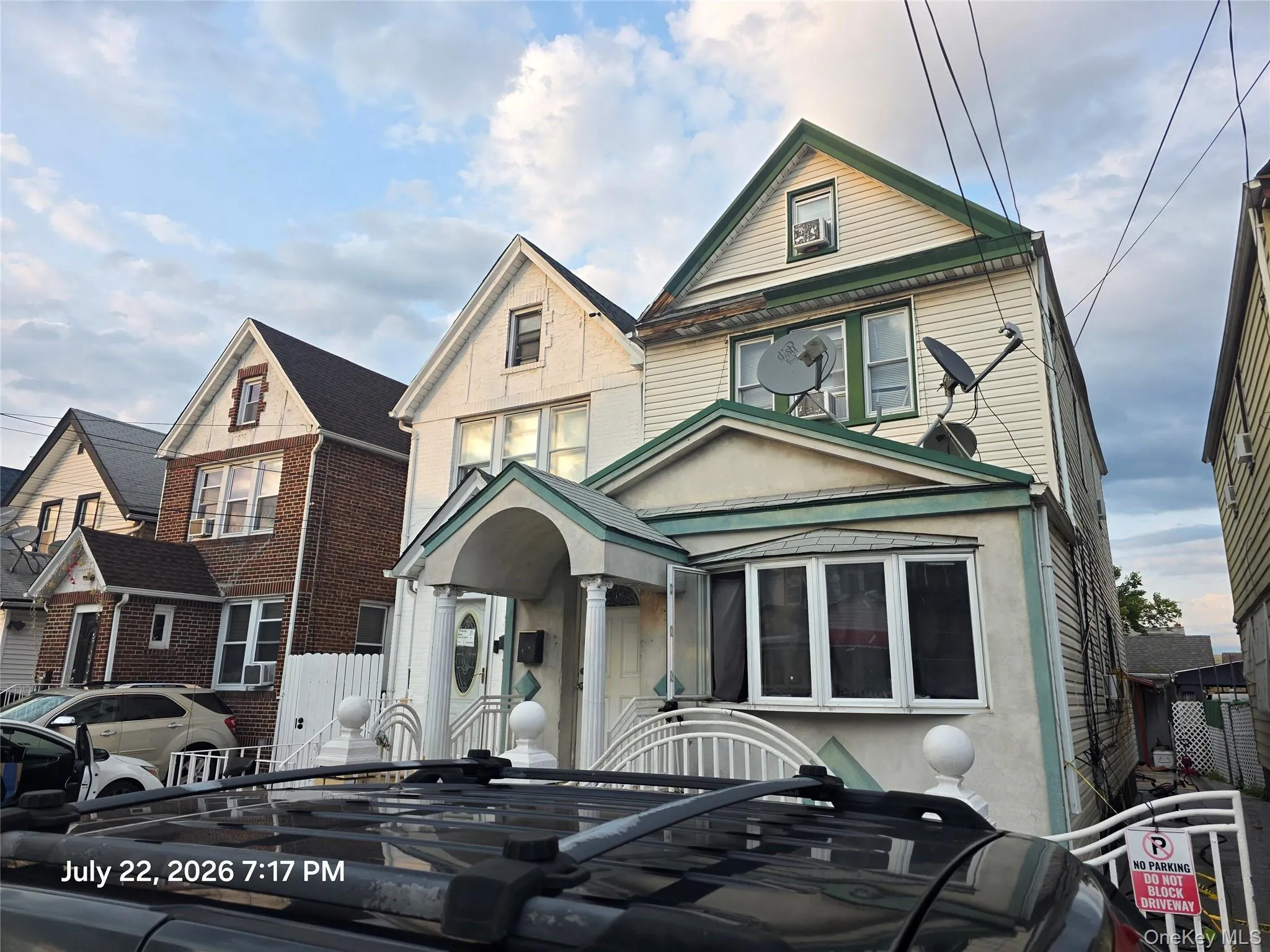 The property features a stucco and siding exterior with a pitched roof, a covered entry with columns, and a bay window The property features a stucco and siding exterior with a pitched roof, a covered entry with columns, and a bay window