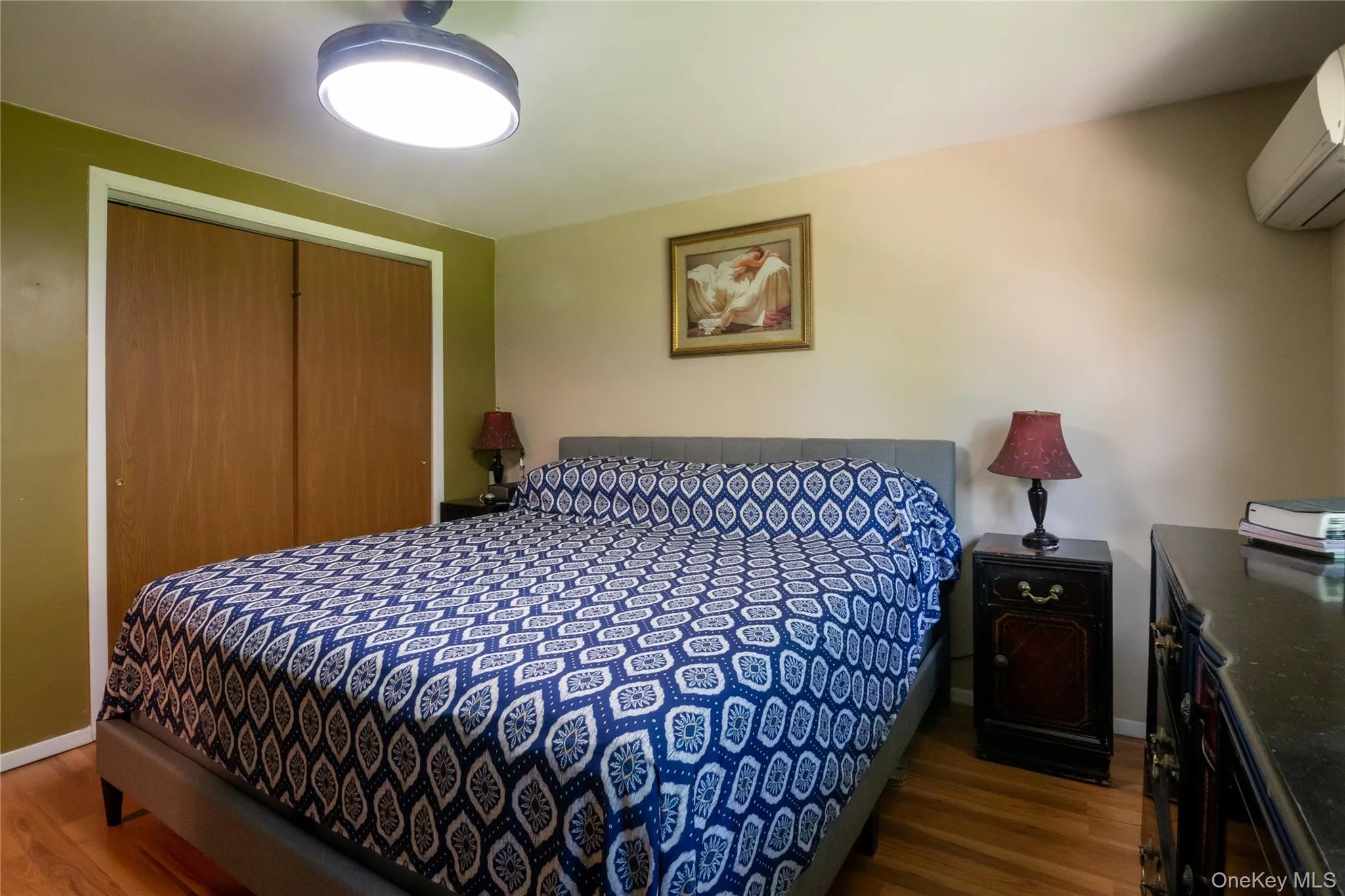 Primary bedroom with generous closet space, warm-toned flooring, and comfortable proportions. Primary bedroom with generous closet space, warm-toned flooring, and comfortable proportions.