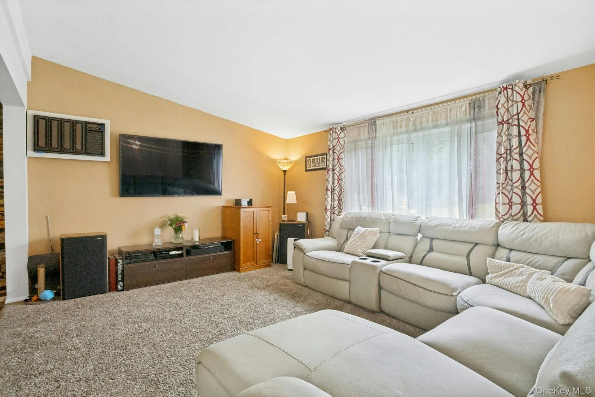 Alternate view of the living room highlighting the generous layout, natural light, and flexible furniture space Alternate view of the living room highlighting the generous layout, natural light, and flexible furniture space