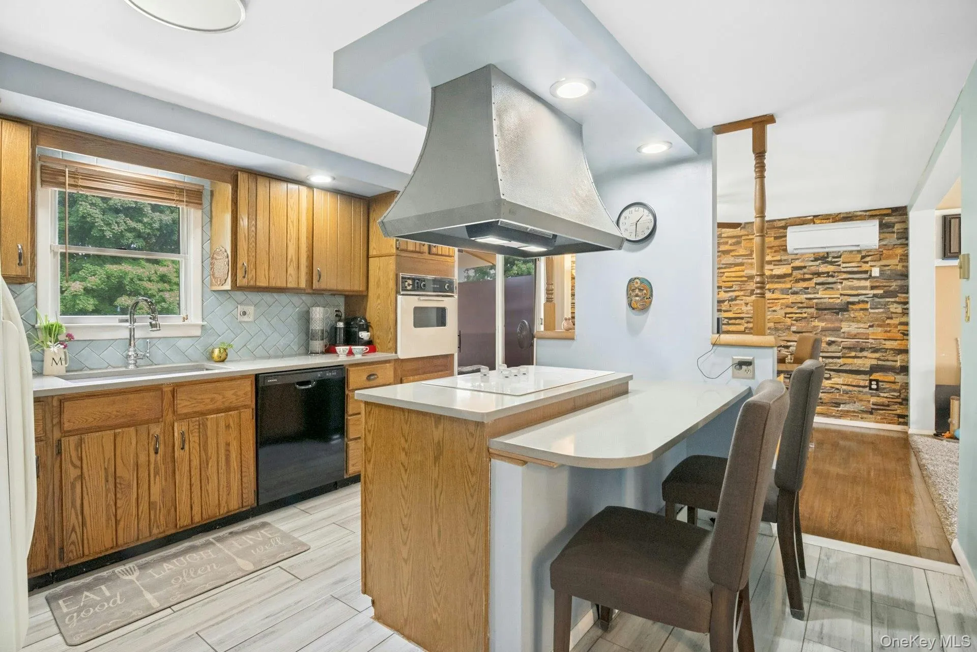 Alternate kitchen view highlighting the center island, breakfast seating, and open connection to the dining area. Alternate kitchen view highlighting the center island, breakfast seating, and open connection to the dining area.