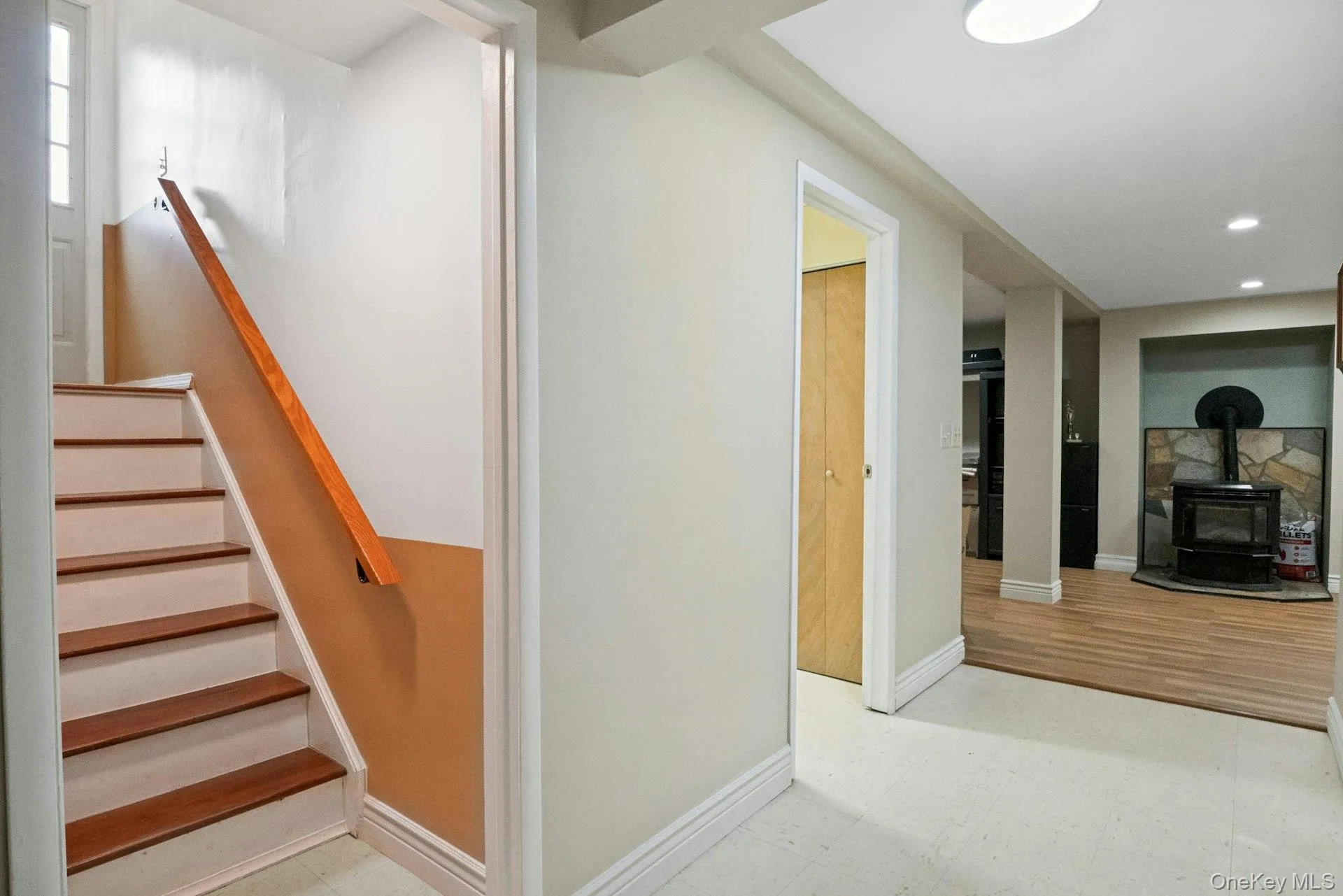 Lower-level hallway connecting the staircase, laundry area, family room, and multipurpose space. Lower-level hallway connecting the staircase, laundry area, family room, and multipurpose space.