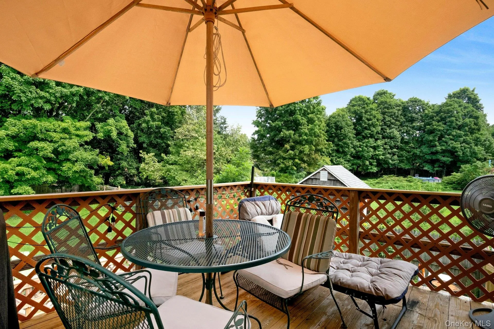 Upper deck with outdoor seating and views of the surrounding yard. Upper deck with outdoor seating and views of the surrounding yard.