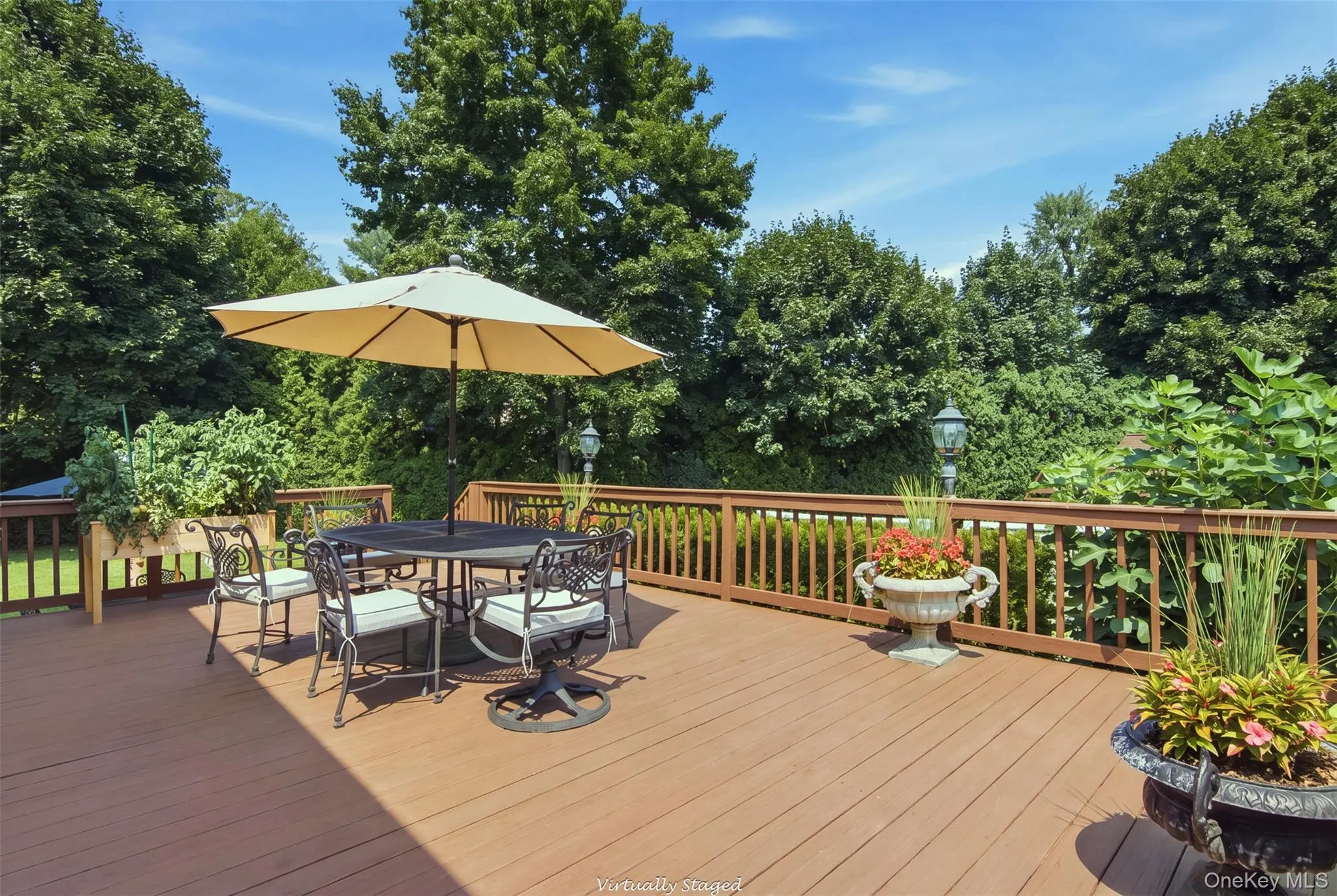 Expansive outdoor deck with a brown wood-finish surface, complete with a surrounding railing Expansive outdoor deck with a brown wood-finish surface, complete with a surrounding railing