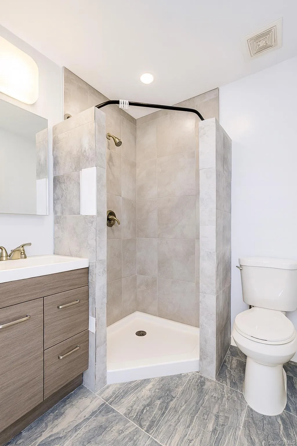 Bathroom featuring vanity and a stall shower Bathroom featuring vanity and a stall shower