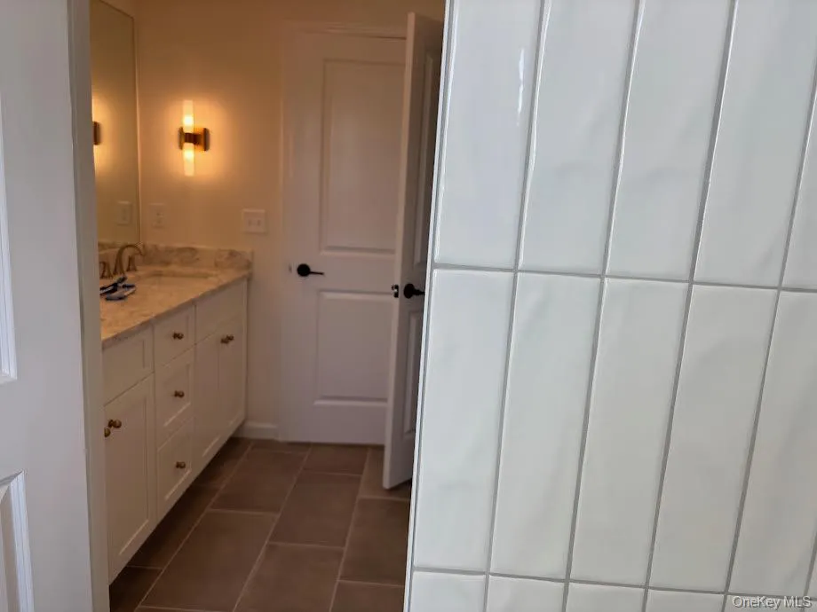 Bathroom featuring tile patterned flooring and vanity Bathroom featuring tile patterned flooring and vanity