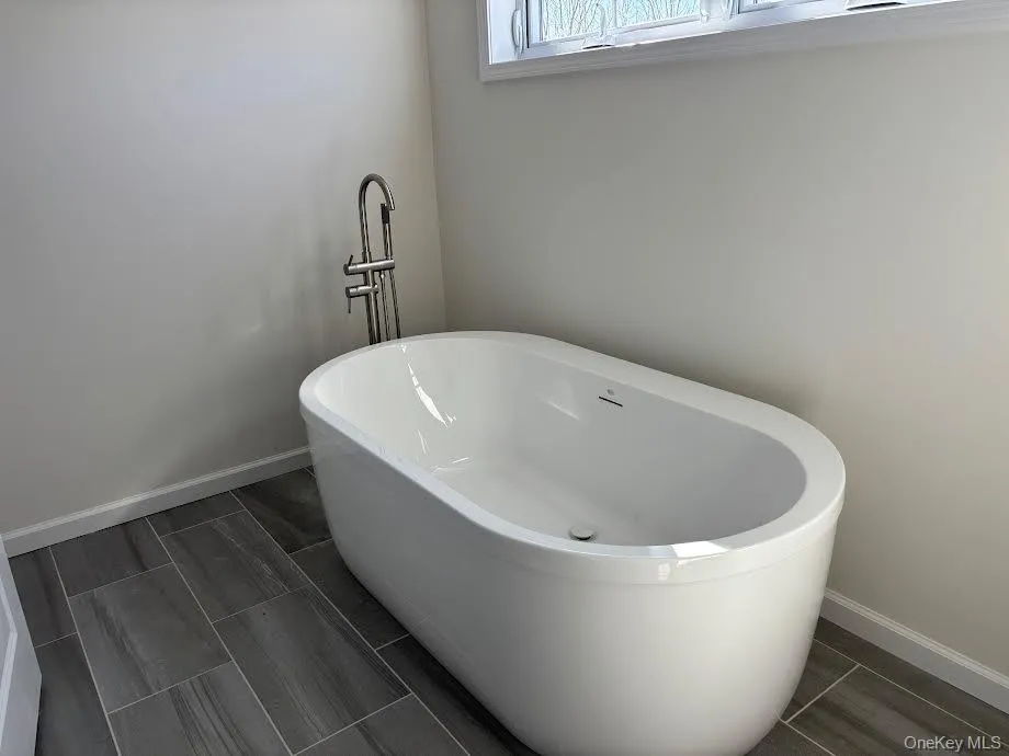 Bathroom featuring a bath Bathroom featuring a bath