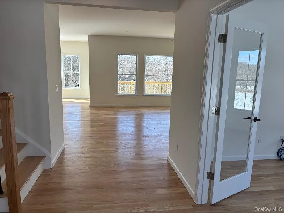 Hallway featuring light hardwood / wood-style floors and a wealth of natural light Hallway featuring light hardwood / wood-style floors and a wealth of natural light