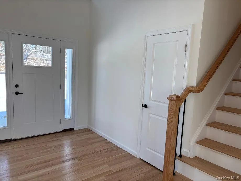 Foyer entrance featuring light hardwood / wood-style floors Foyer entrance featuring light hardwood / wood-style floors