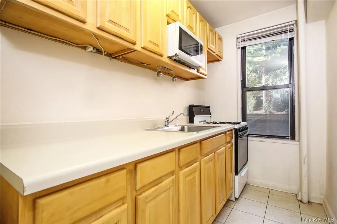 Here is a view of the kitchen featuring great cabinet space, counter space and microwave. Here is a view of the kitchen featuring great cabinet space, counter space and microwave.