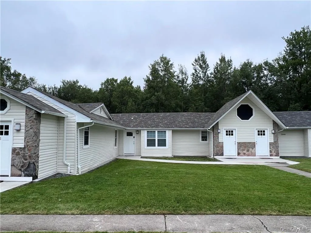 Single story home featuring a front lawn Single story home featuring a front lawn