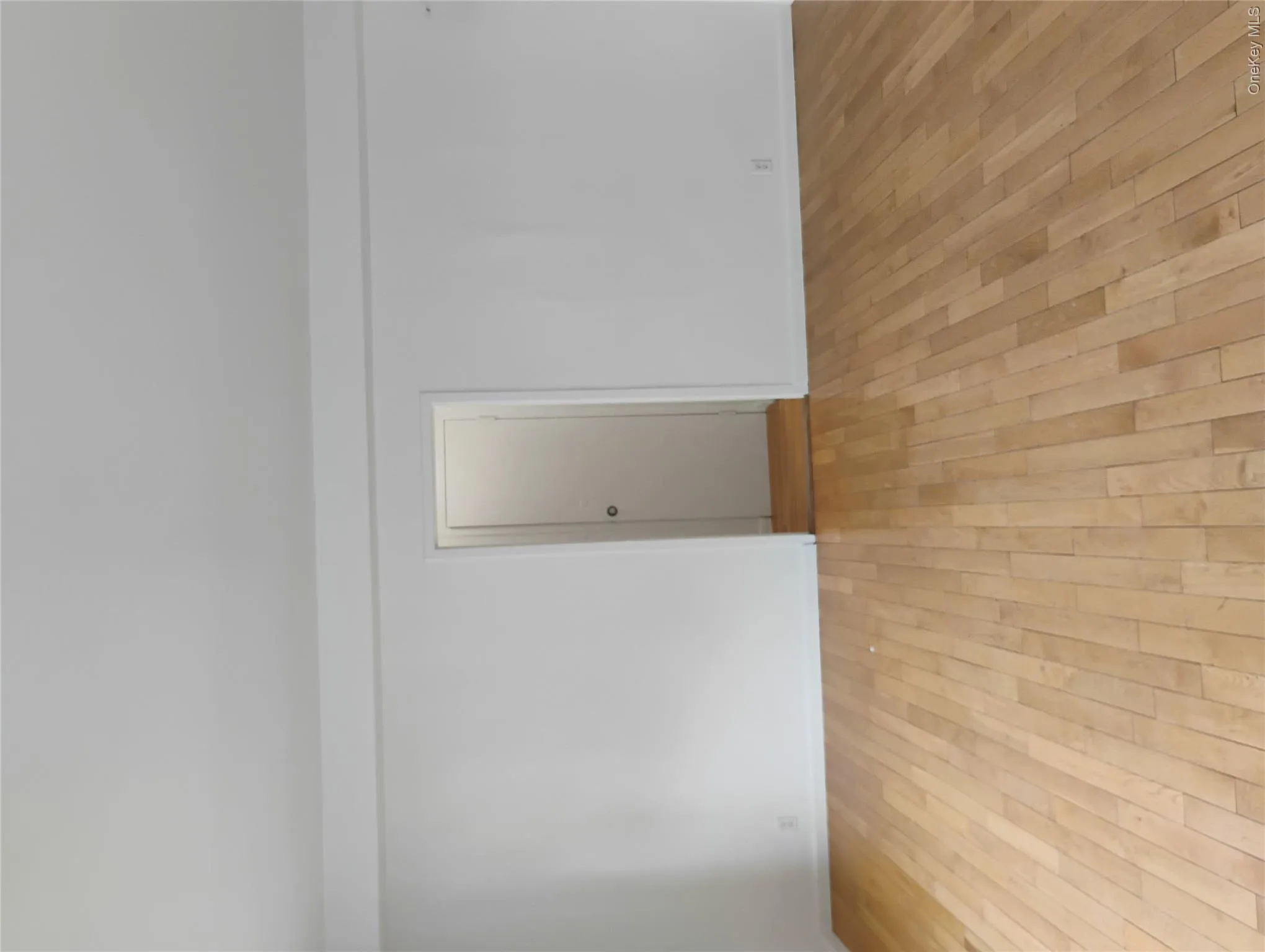 Light wood-finish flooring with white walls and trim Light wood-finish flooring with white walls and trim