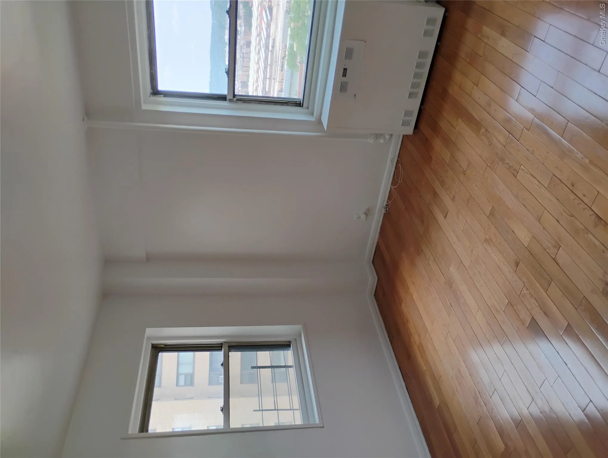 Wood-finish flooring with white baseboards Wood-finish flooring with white baseboards