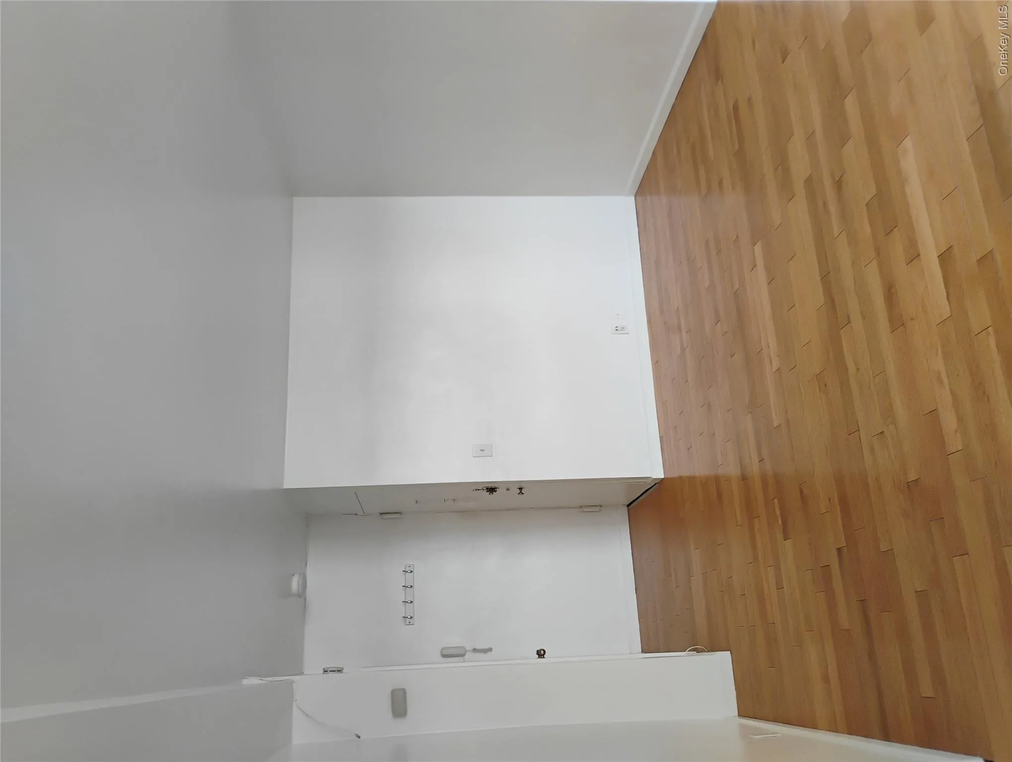 Bright, open interior space featuring warm wood-finish flooring throughout, white drywall surfaces, and recessed lighting Bright, open interior space featuring warm wood-finish flooring throughout, white drywall surfaces, and recessed lighting