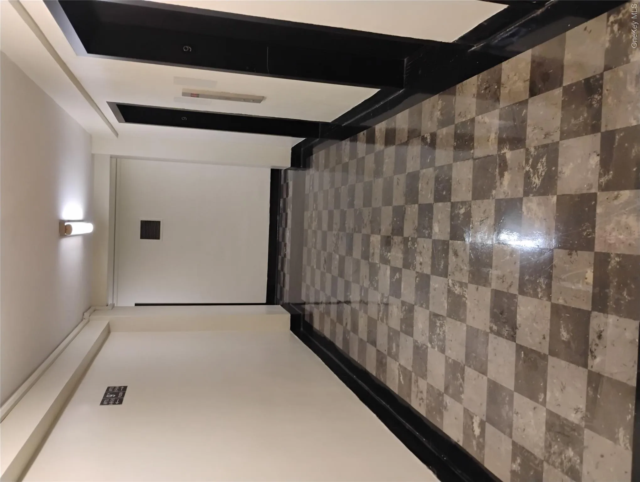 Communal hallway and elevator bay. Communal hallway and elevator bay.