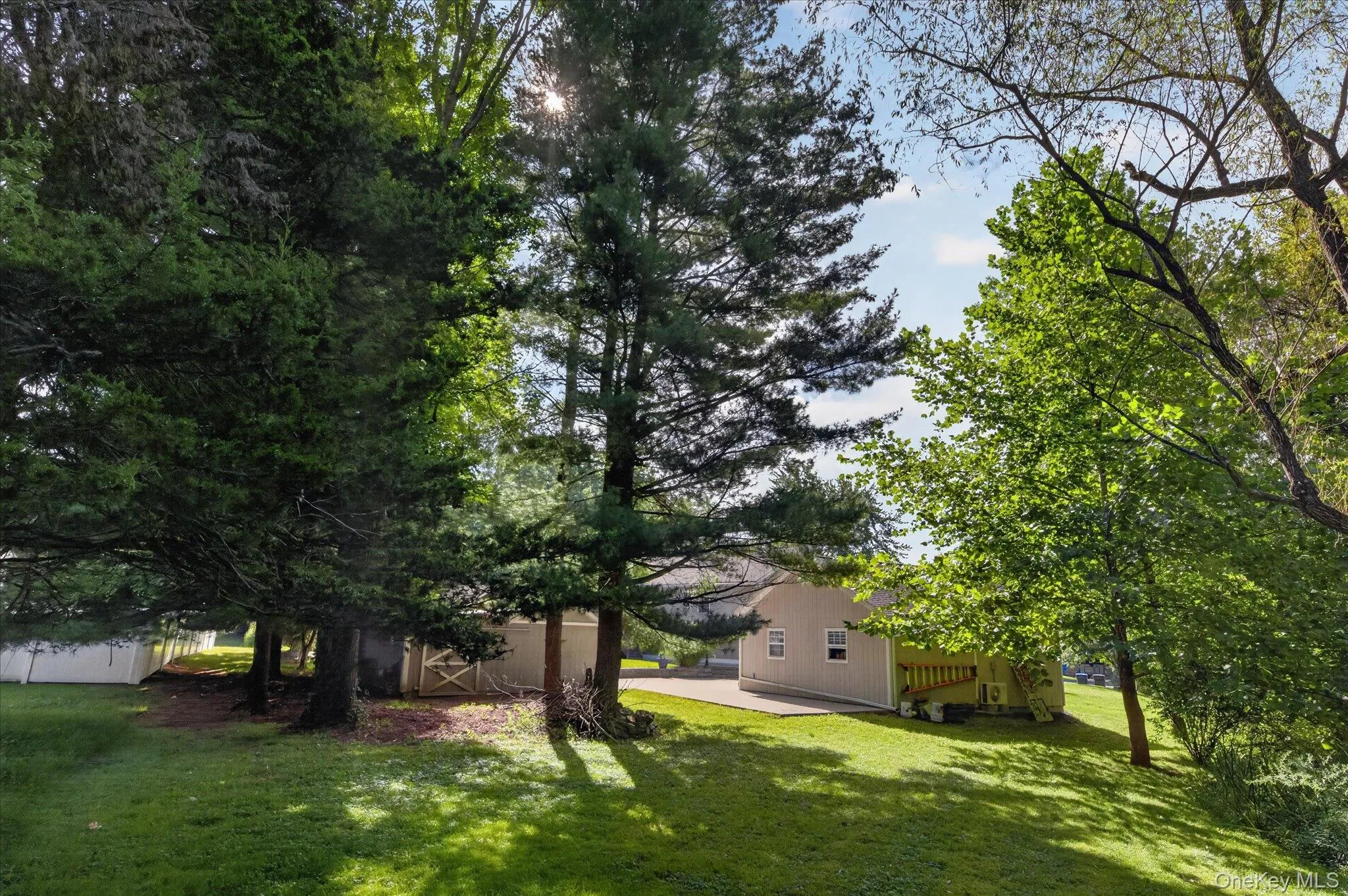 Expansive yard featuring mature trees and a manicured lawn Expansive yard featuring mature trees and a manicured lawn