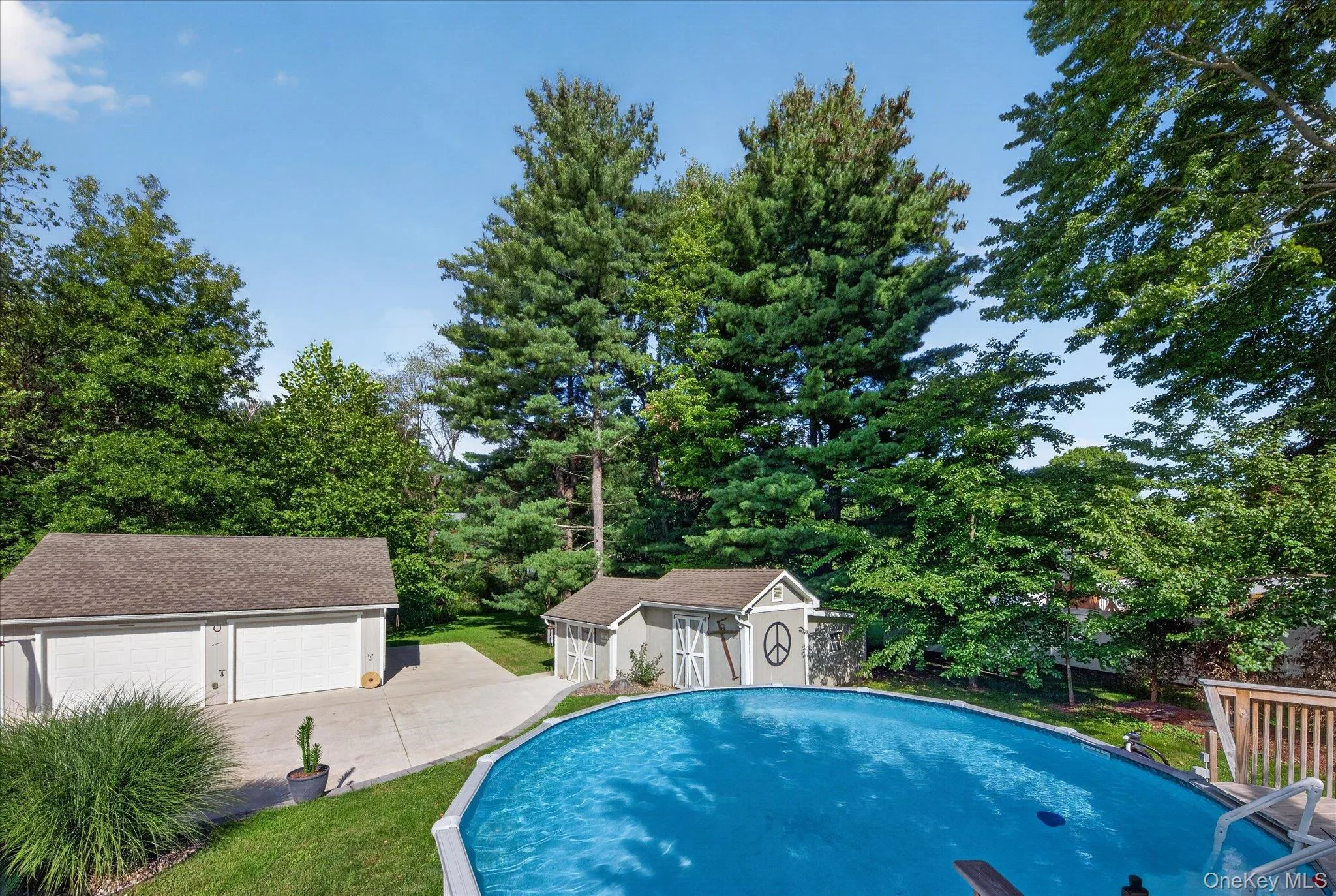 Outdoor swimming pool, two-car detached garage, paved driveway, separate storage shed, mature trees Outdoor swimming pool, two-car detached garage, paved driveway, separate storage shed, mature trees