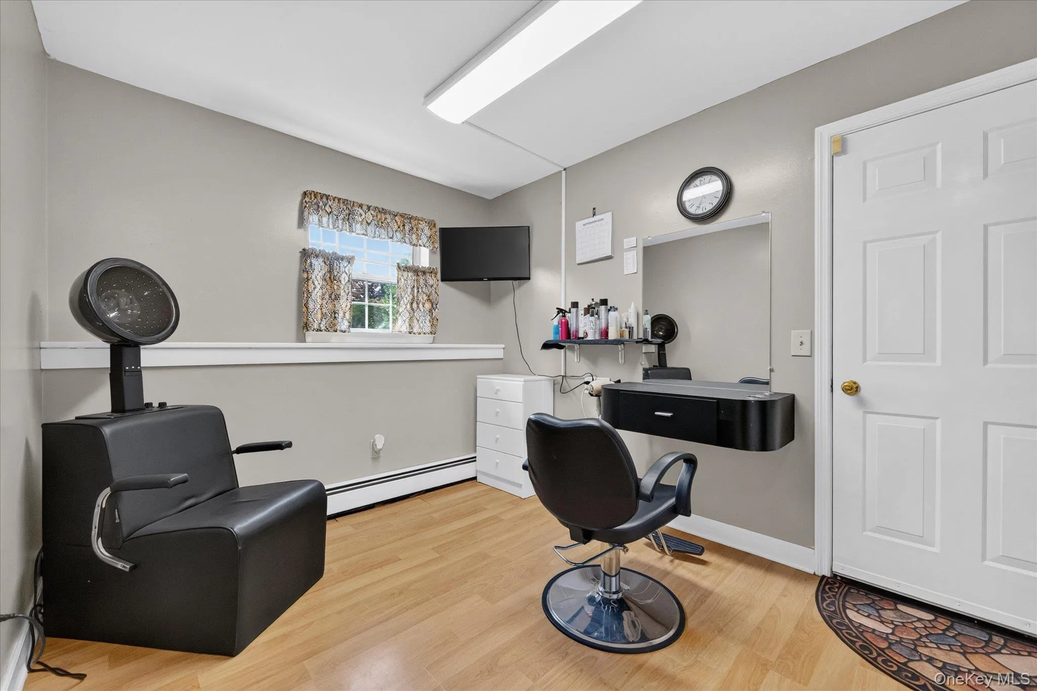 Neutral wall paint, light wood-finish flooring, white trim, recessed lighting, and a paneled door Neutral wall paint, light wood-finish flooring, white trim, recessed lighting, and a paneled door