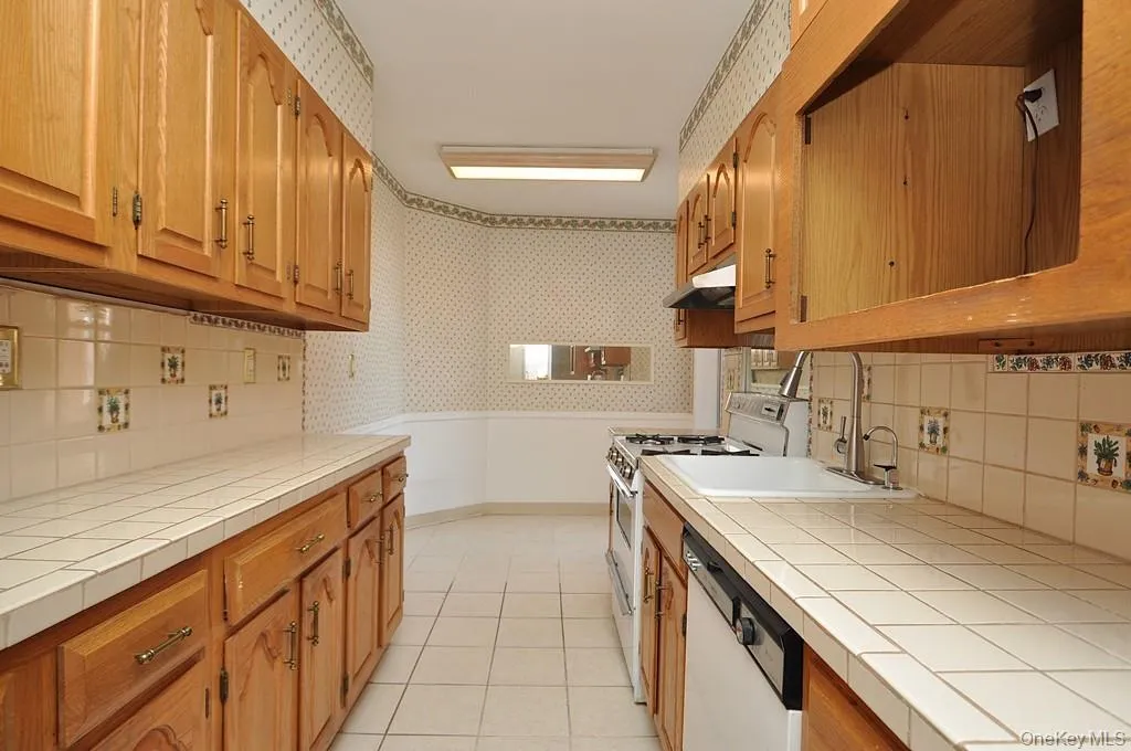 Eat-in kitchen has plenty of cabinets and counter space as well as a dishwasher, range and refrigerator. The kitchen is approx. 21'-7" x 7'-1" Eat-in kitchen has plenty of cabinets and counter space as well as a dishwasher, range and refrigerator. The kitchen is approx. 21'-7" x 7'-1"