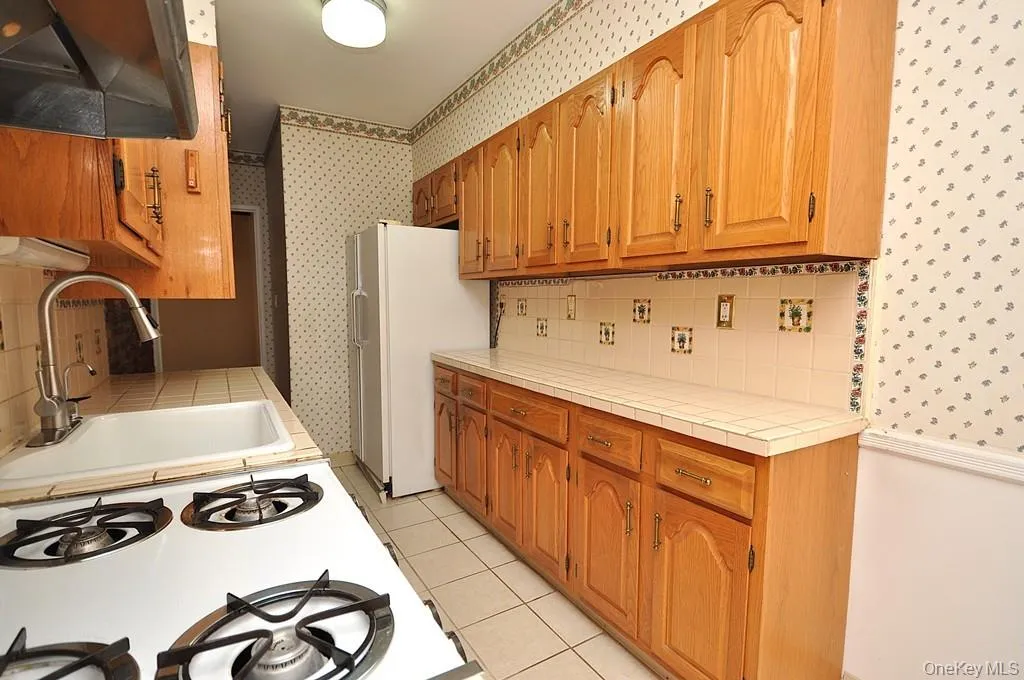 Eat-in kitchen has plenty of cabinets and counter space as well as a dishwasher, range and refrigerator. The kitchen is approx. 21'-7" x 7'-1" Eat-in kitchen has plenty of cabinets and counter space as well as a dishwasher, range and refrigerator. The kitchen is approx. 21'-7" x 7'-1"