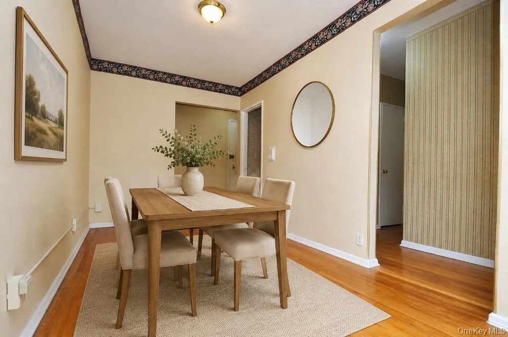 Photo Visually Staged. The dining area opens to the living room and has hardwood floors. The dining area is approx. 13'-0" x 8'-3". Photo Visually Staged. The dining area opens to the living room and has hardwood floors. The dining area is approx. 13'-0" x 8'-3".