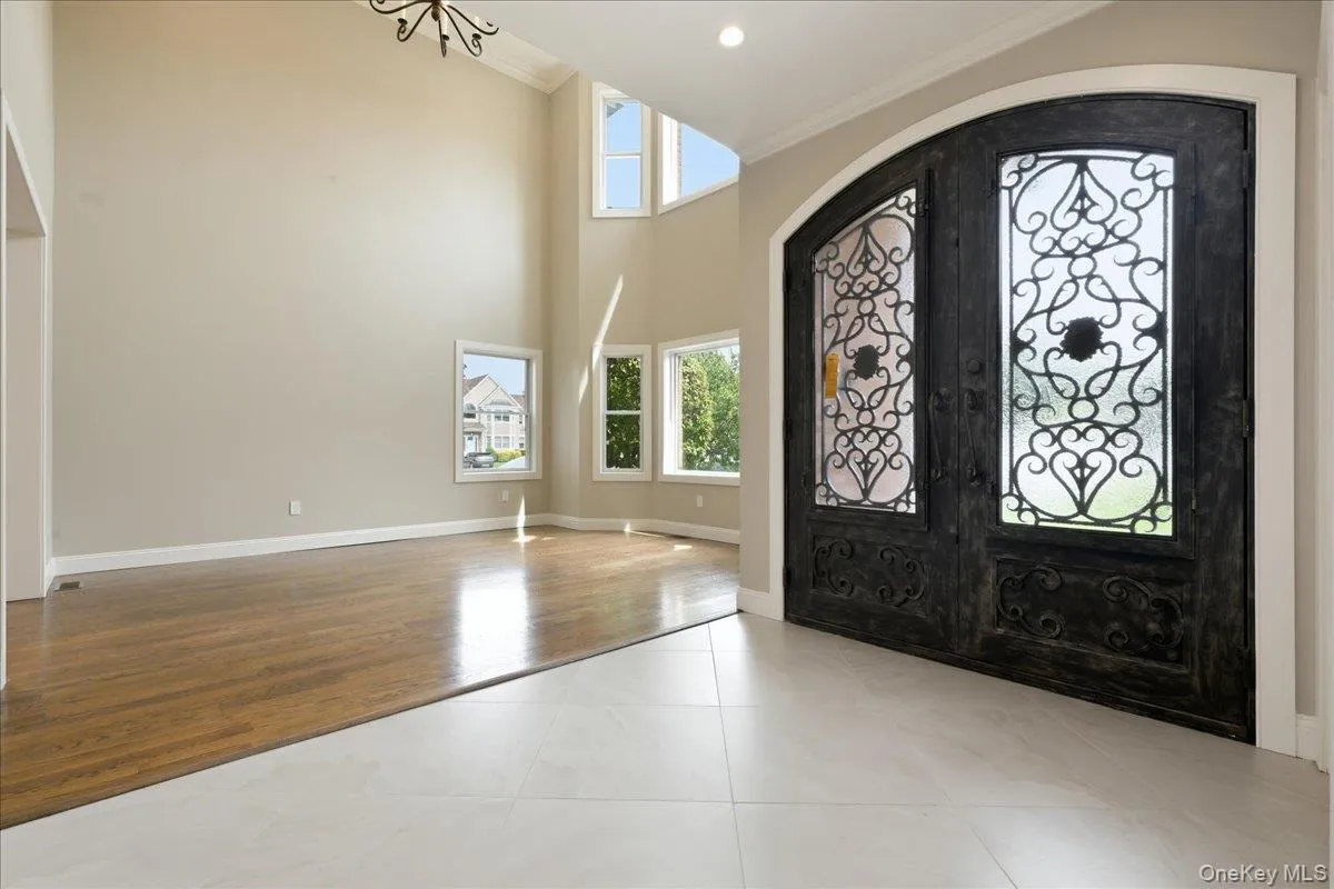 Grand double-door entry with decorative ironwork Grand double-door entry with decorative ironwork
