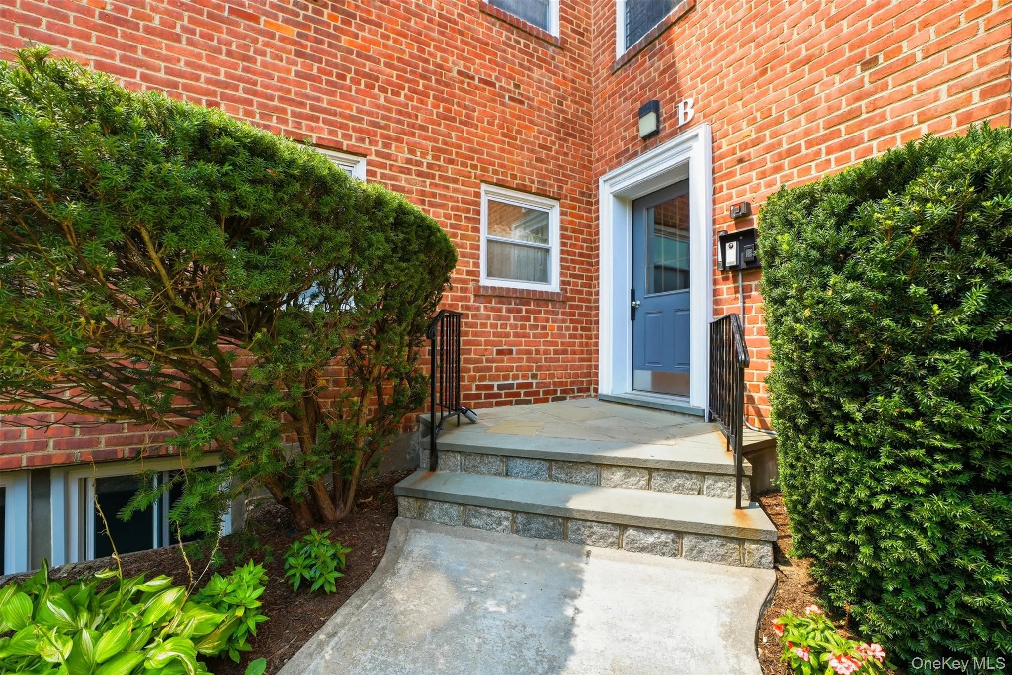 Welcome home! This inviting entryway showcases beautiful brickwork, lush green bushes, and a bright, welcoming front door. Welcome home! This inviting entryway showcases beautiful brickwork, lush green bushes, and a bright, welcoming front door.