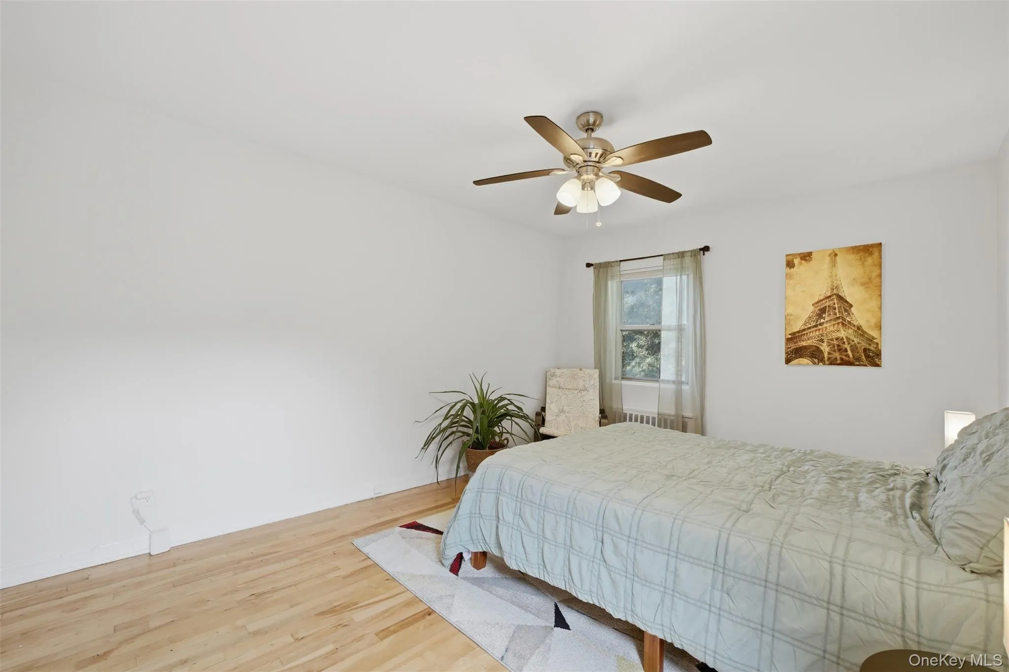 Relax in this serene bedroom retreat! This peaceful space offers gorgeous hardwood floors, a cooling ceiling fan, and ample room to incorporate a cozy reading nook or seating area. Relax in this serene bedroom retreat! This peaceful space offers gorgeous hardwood floors, a cooling ceiling fan, and ample room to incorporate a cozy reading nook or seating area.