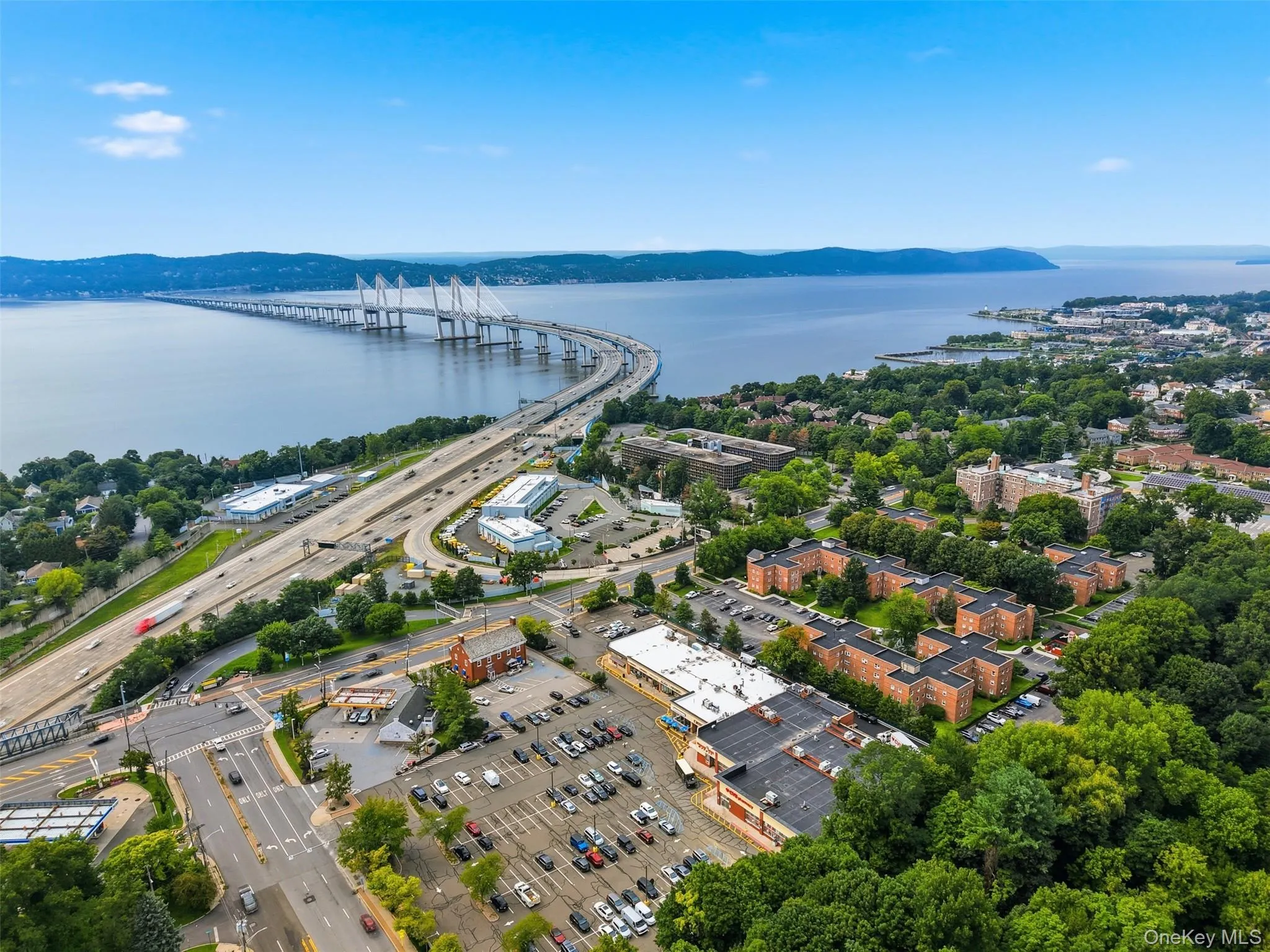 Fantastic bird's-eye view showcasing the expansive community grounds, well-maintained brick buildings, convenient on-site parking, and the stunning backdrop of the Hudson River and Mario M. Cuomo Bridge. Fantastic bird's-eye view showcasing the expansive community grounds, well-maintained brick buildings, convenient on-site parking, and the stunning backdrop of the Hudson River and Mario M. Cuomo Bridge.