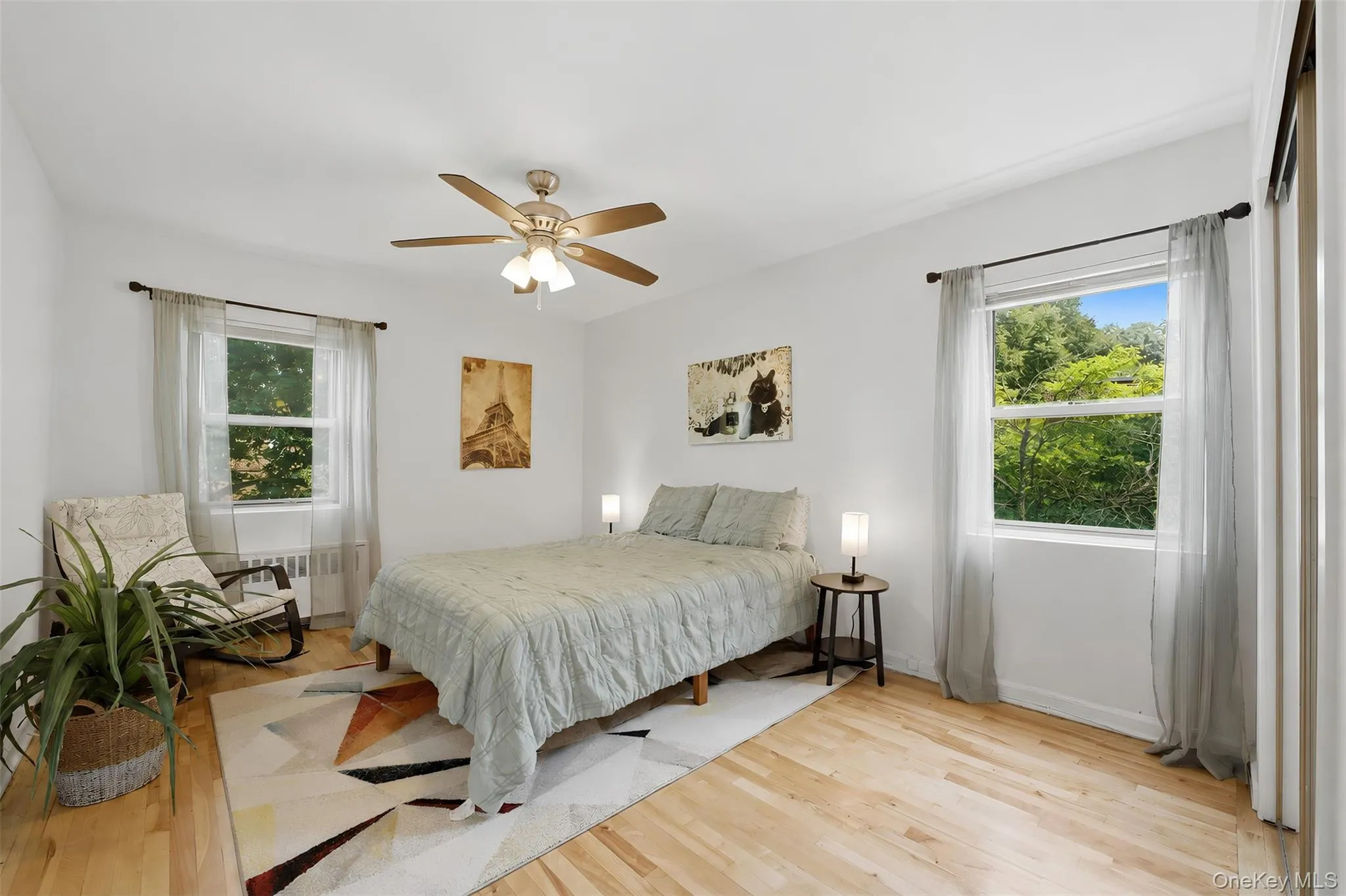 Relax in this serene bedroom retreat! This peaceful space offers gorgeous hardwood floors, a cooling ceiling fan, and ample room to incorporate a cozy reading nook or seating area. Relax in this serene bedroom retreat! This peaceful space offers gorgeous hardwood floors, a cooling ceiling fan, and ample room to incorporate a cozy reading nook or seating area.