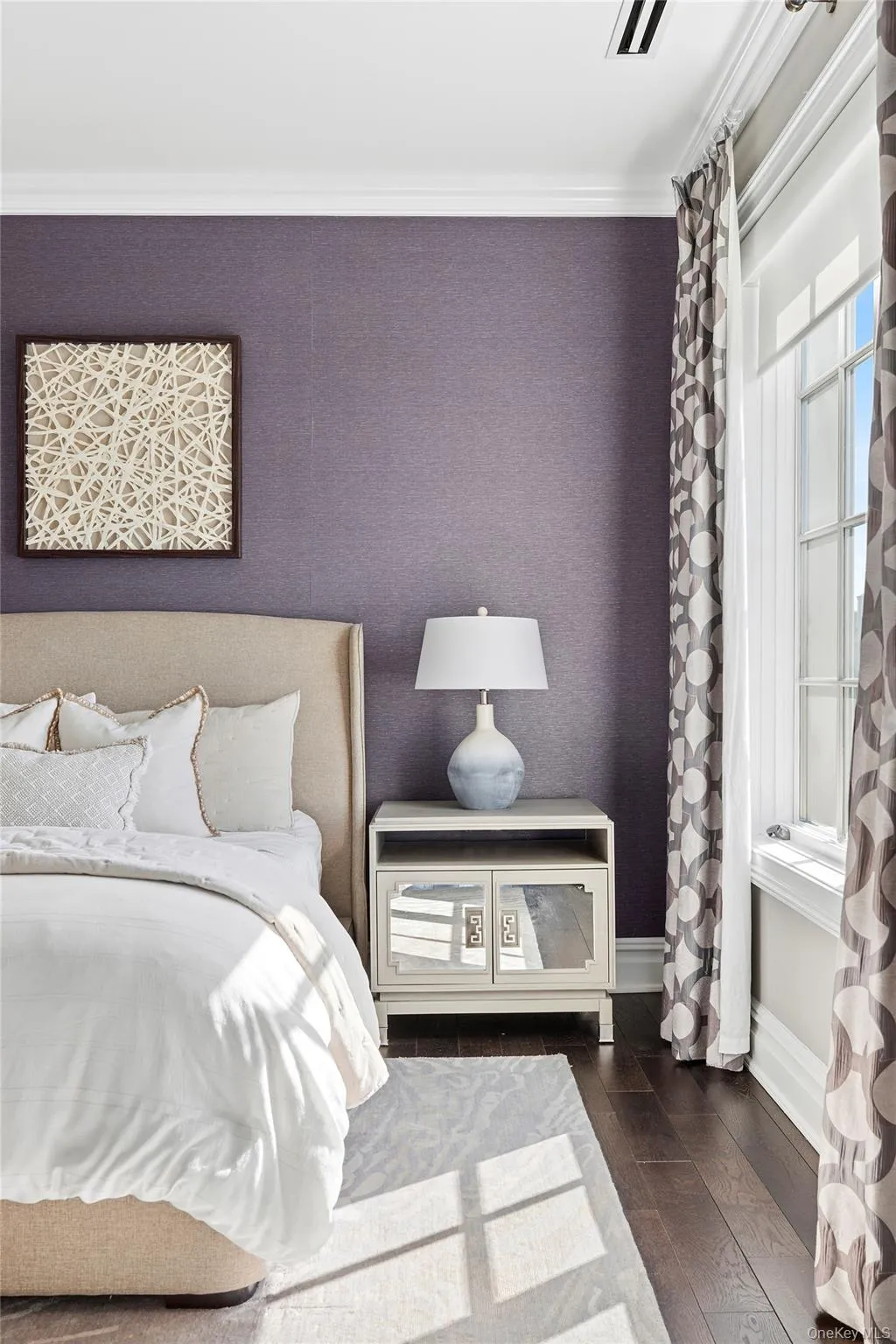 Bedroom featuring baseboards, ornamental molding, and hardwood / wood-style flooring Bedroom featuring baseboards, ornamental molding, and hardwood / wood-style flooring