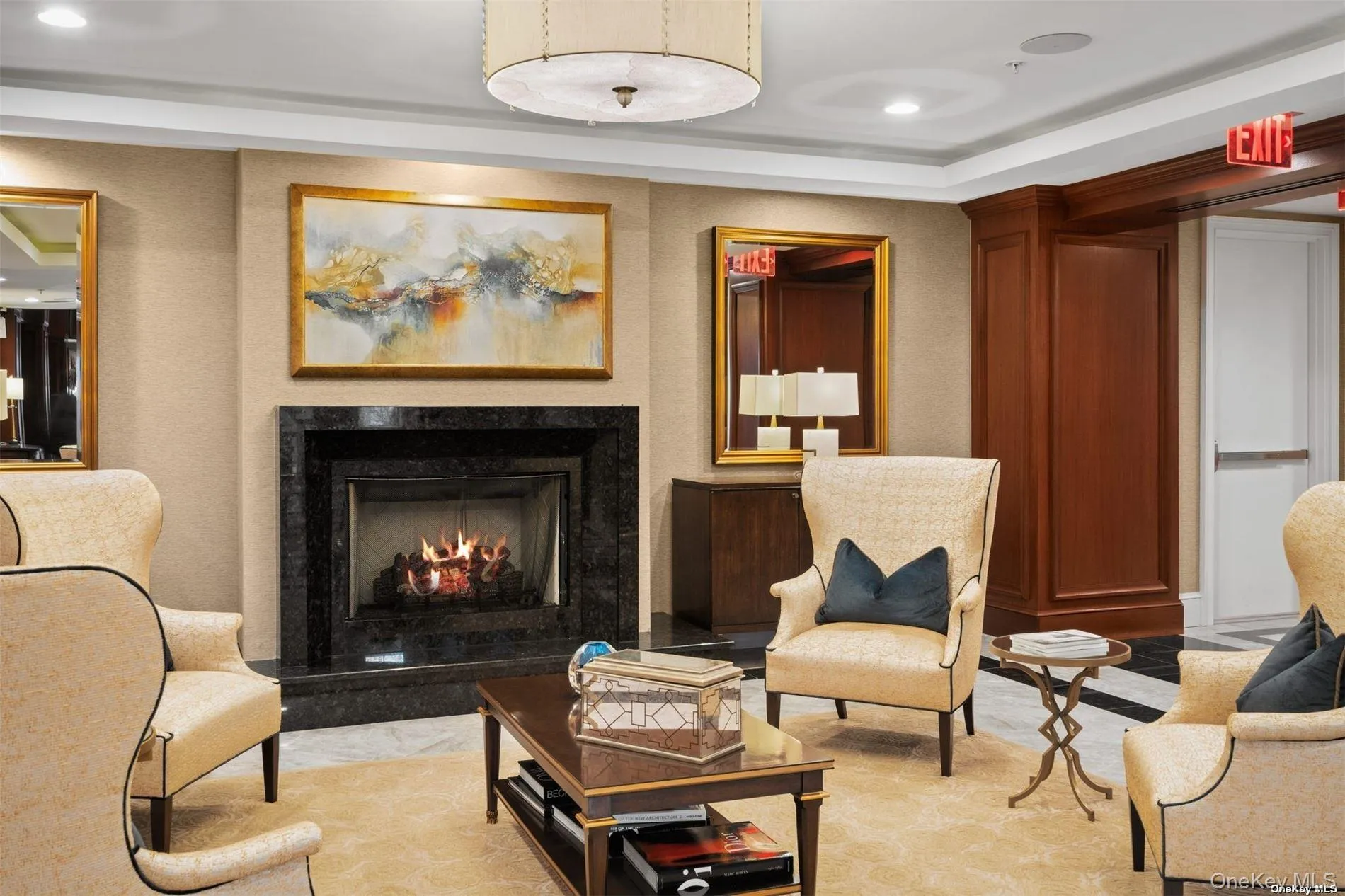 Living area with recessed lighting, a raised ceiling, and a high end fireplace Living area with recessed lighting, a raised ceiling, and a high end fireplace