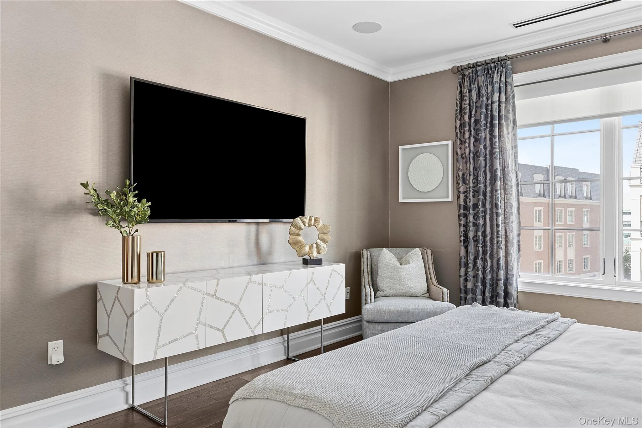 Bedroom with baseboards, ornamental molding, wood finished floors, and multiple windows Bedroom with baseboards, ornamental molding, wood finished floors, and multiple windows