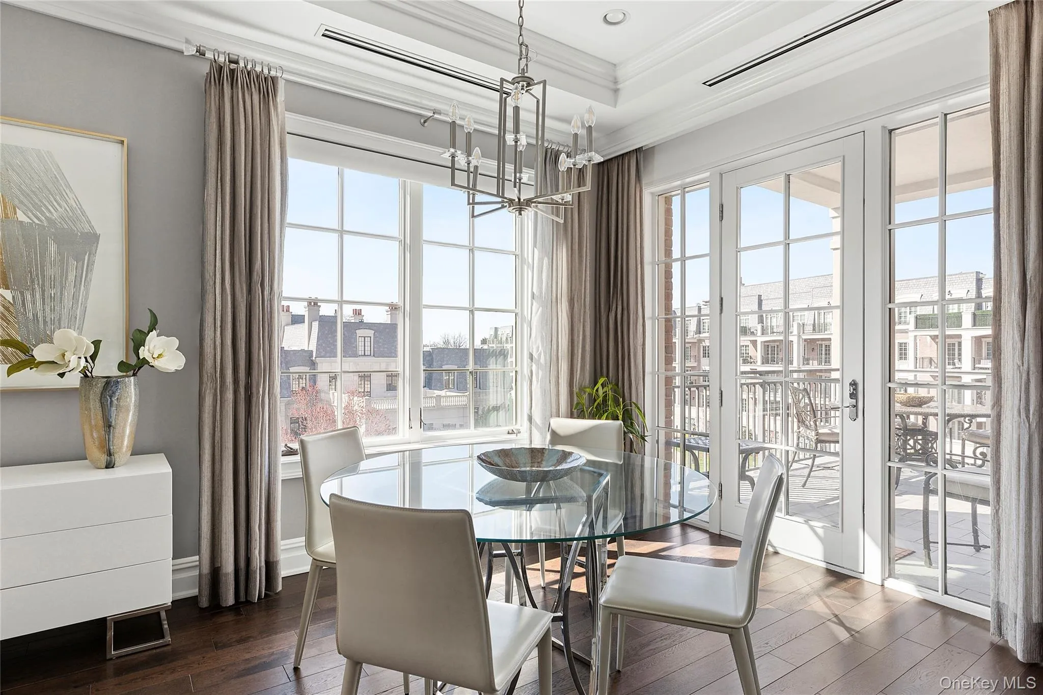 Dining area with crown molding, dark wood-style flooring, and a chandelier Dining area with crown molding, dark wood-style flooring, and a chandelier