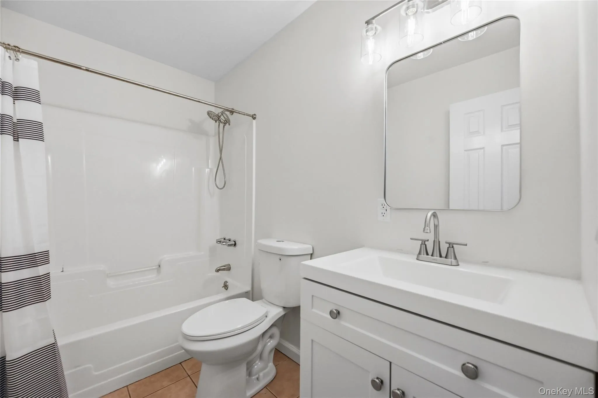 White vanity with integrated sink, brushed nickel faucet, and contemporary mirror White vanity with integrated sink, brushed nickel faucet, and contemporary mirror